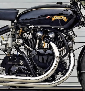 Close-up of Vincent Black Shadow motorcycle V-twin engine with chrome exhaust pipes and black tank