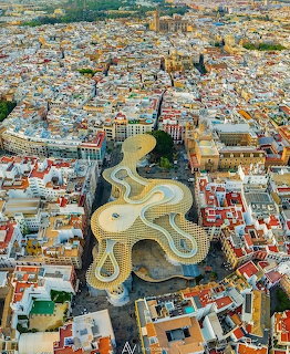 Aerial photograph of Seville Spain with the Metropol Parasol structure visible among city rooftops