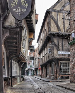 Narrow cobbled street with old timber-framed buildings in York, England