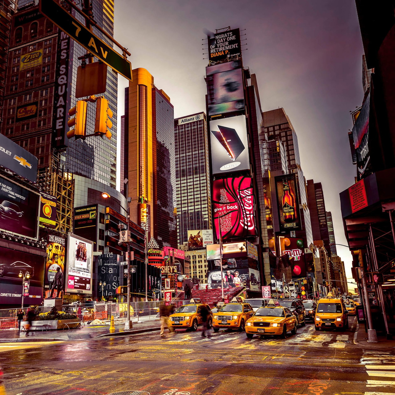Yellow taxis in Times Square with illuminated billboards and tall buildings in New York City