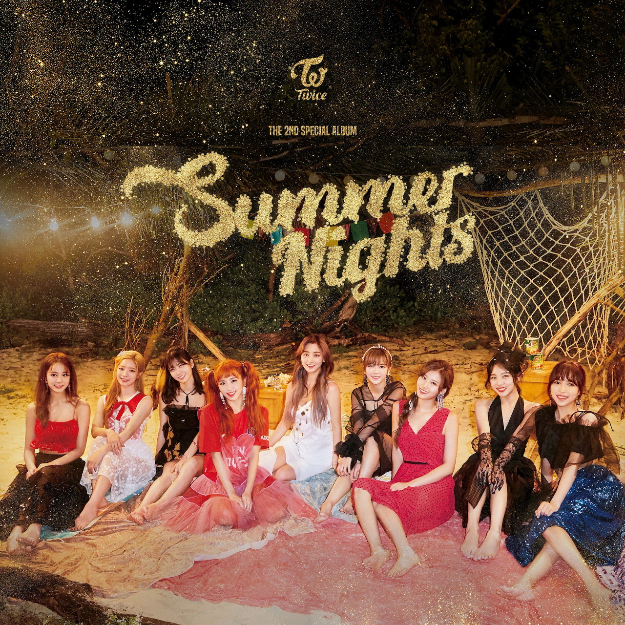 Nine women in colorful outfits posing on a beach at night with sparkler text reading Summer Nights