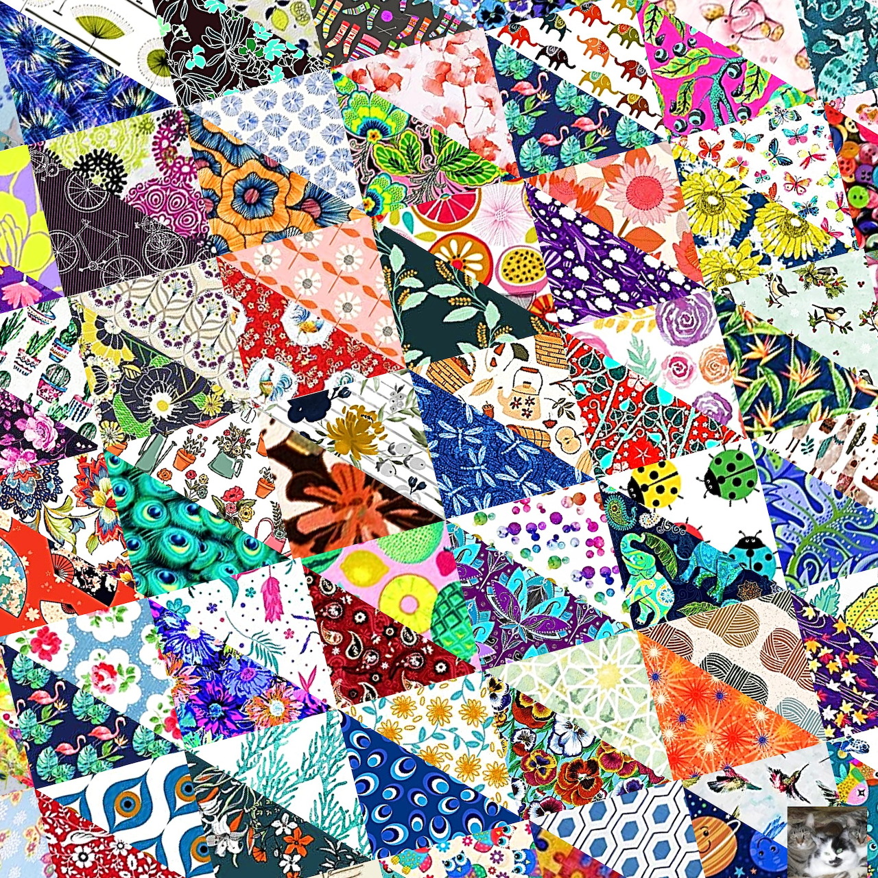 Vibrant patchwork quilt with floral patterns and colorful geometric fabric squares arranged in a dense collage