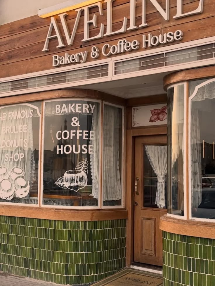 Aveline Bakery and Coffee House exterior with green tiles, wooden door, and painted window signs