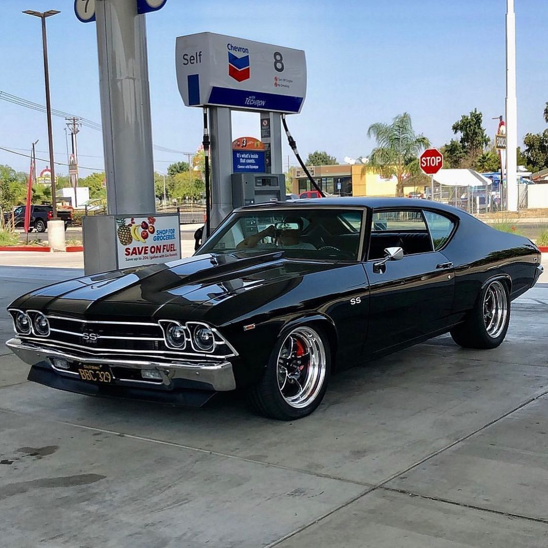 Black Chevrolet Chevelle SS classic car parked at a gas station