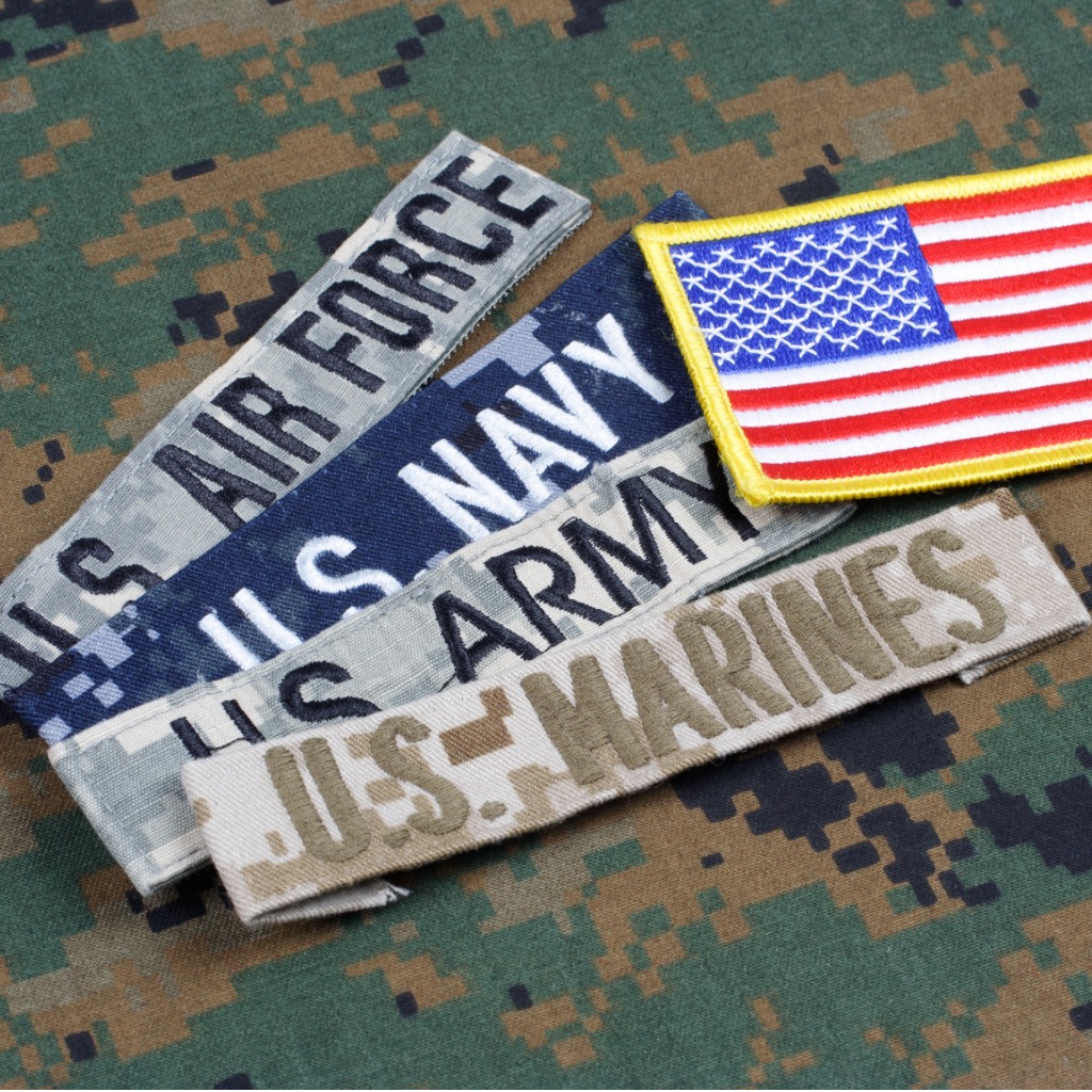 Military name tapes and US flag patch on camo fabric