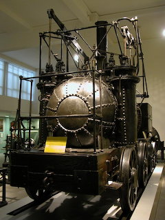 Puffing Billy steam locomotive exhibit in museum with vertical boiler and wheels