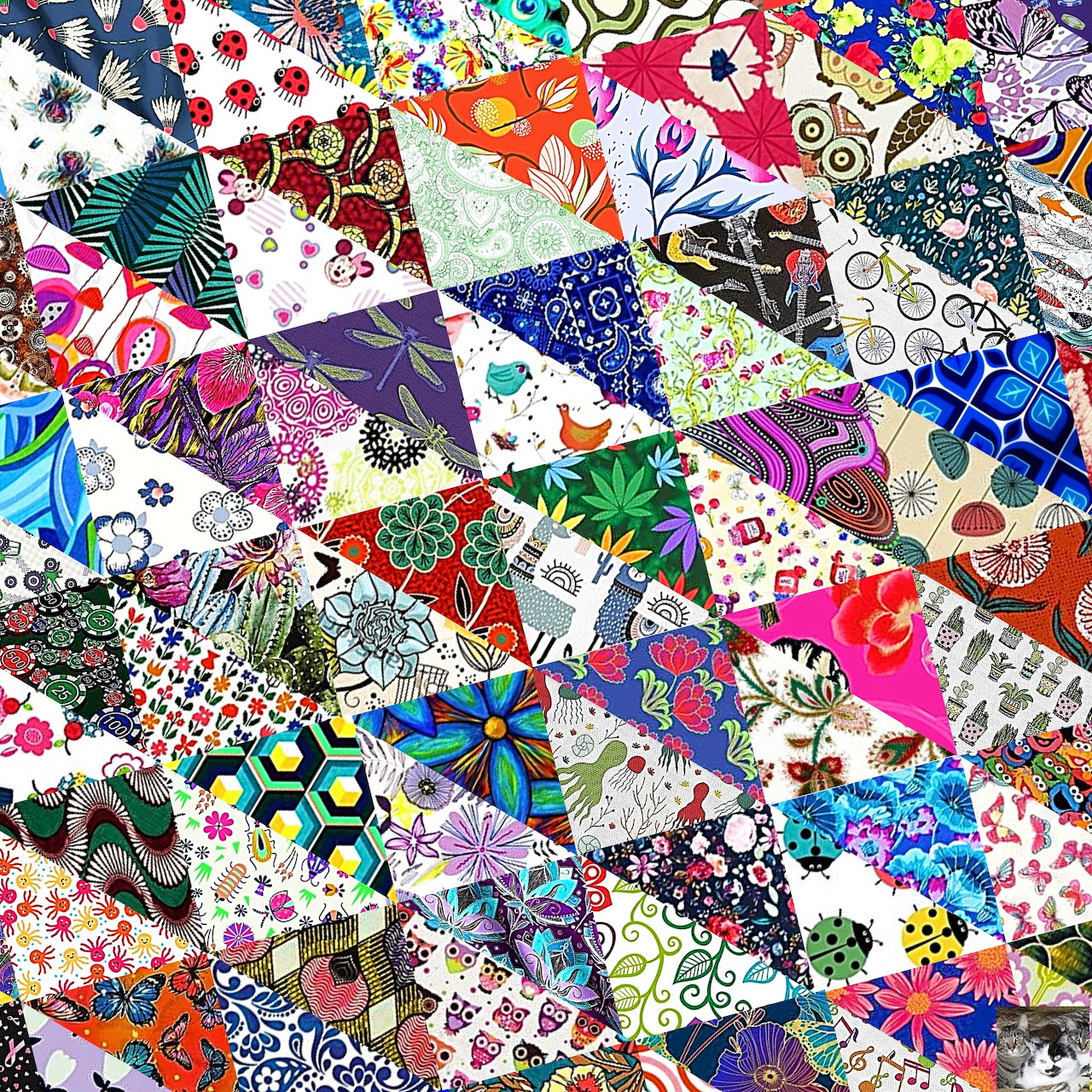 Colorful patchwork quilt with triangular fabric pieces in various patterns and bright colors arranged in a geometric design