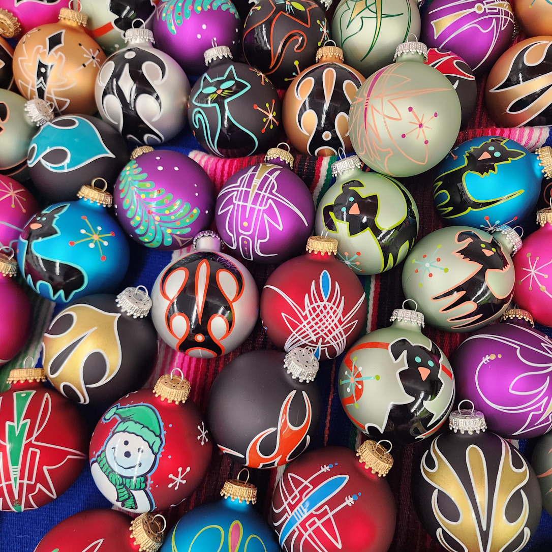 Assorted decorative Christmas ornament balls with painted patterns in bright metallic colors