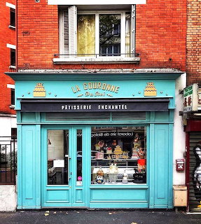 Turquoise French patisserie shopfront named La Couronne with gold signage and pastry display window