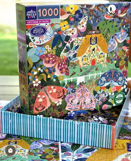 Colorful jigsaw puzzle box showing collage of animated characters with fantasy themes and vibrant artwork