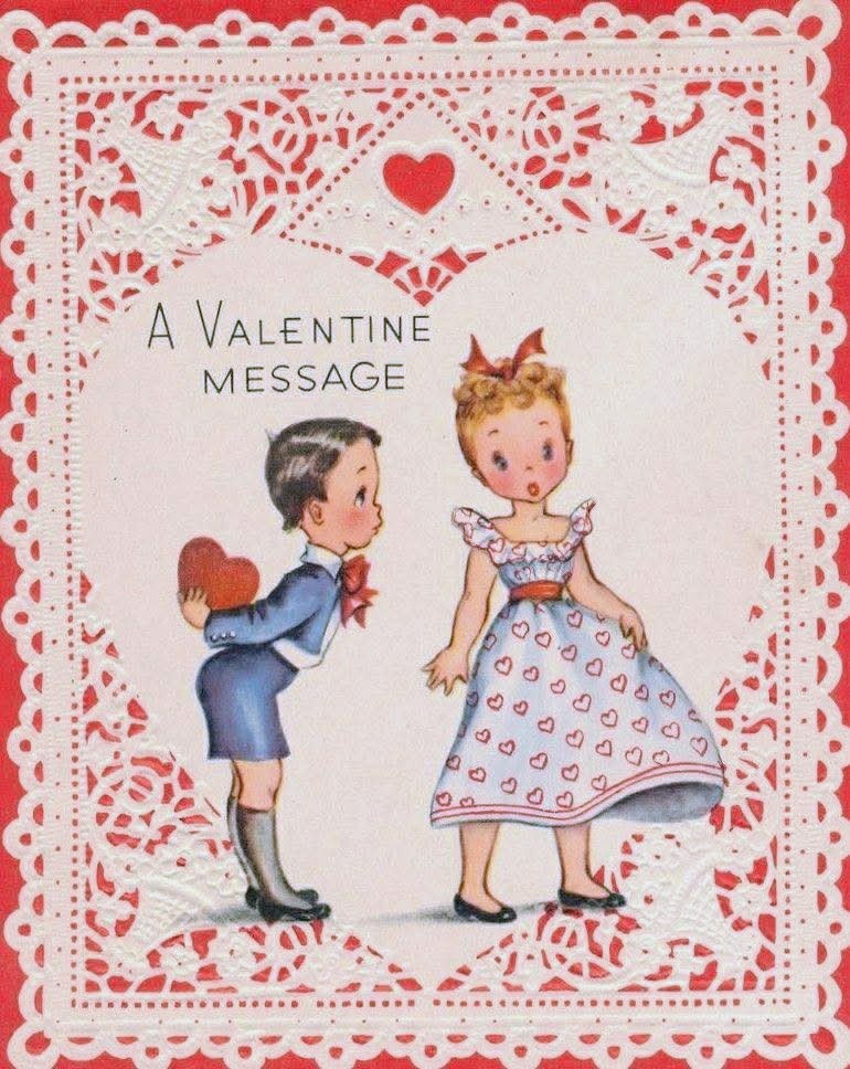 Vintage Valentine card with boy offering heart to girl in dress, framed by lace and red hearts