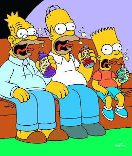 Homer, Marge, and Bart Simpson sitting on orange couch eating popcorn and snacks