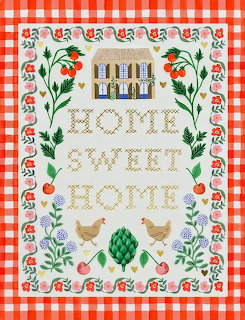 Cross-stitch sampler with cottage, flowers, chickens and Home Sweet Home text on red gingham fabric