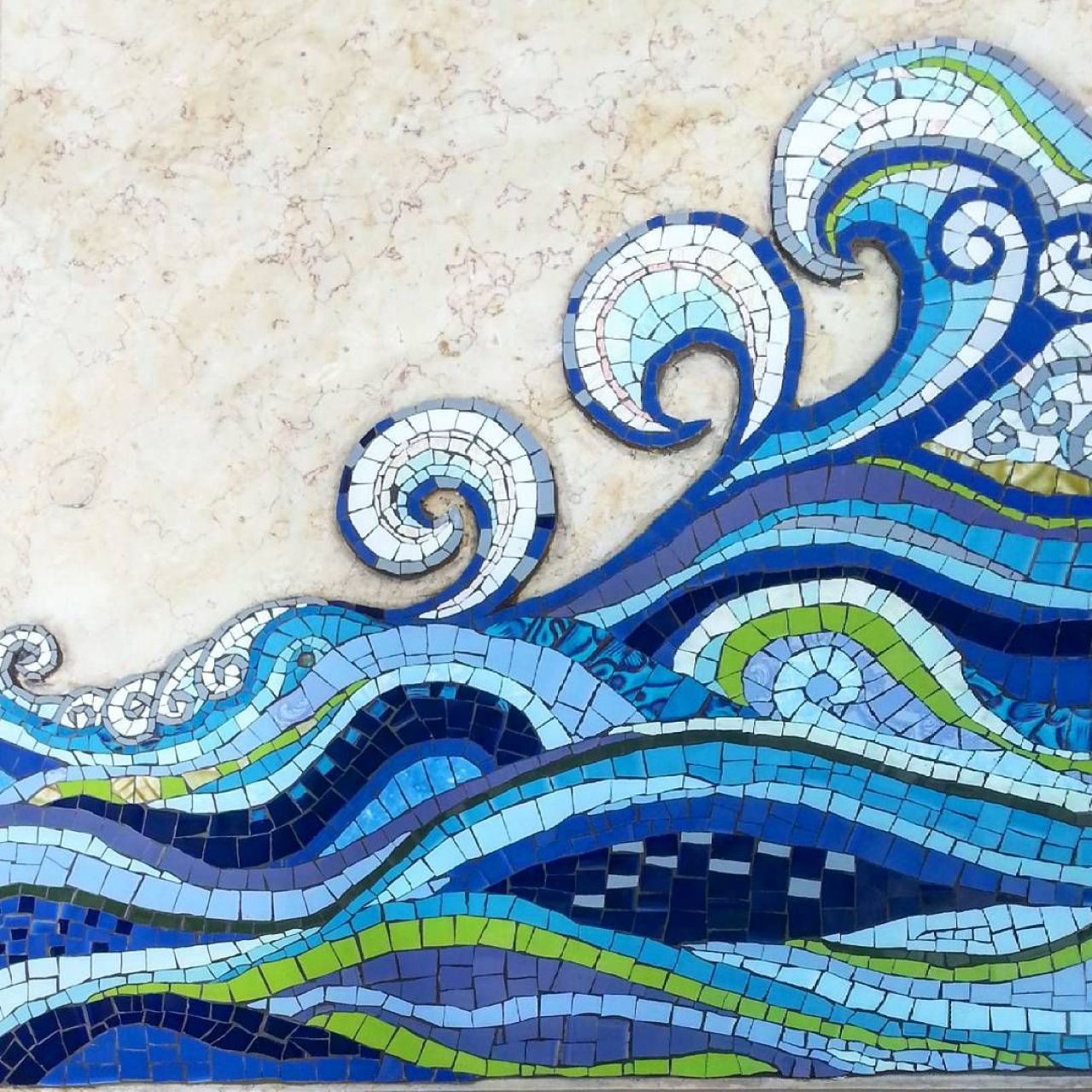 Mosaic art of blue and green ocean waves with decorative spirals on cream background