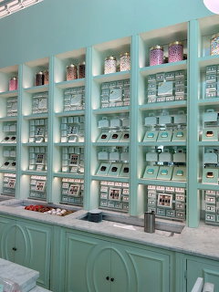 Mint green cafe interior with shelves of boxes, tins, and packaged goods