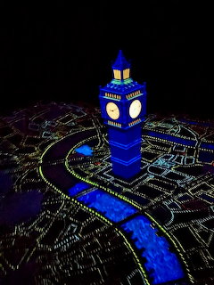 Glowing miniature Big Ben and London city map illuminated in blue and green on Peter Pan's Flight ride