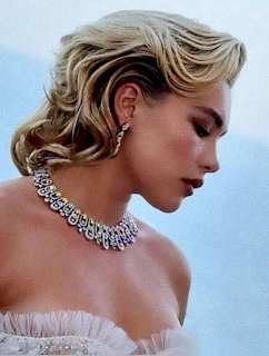Side-profile portrait of Florence Pugh in diamond necklace and earrings with an off-shoulder dress