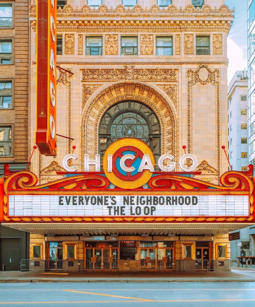 Historic Chicago Theatre with ornate beige facade, vertical Chicago sign, and illuminated marquee