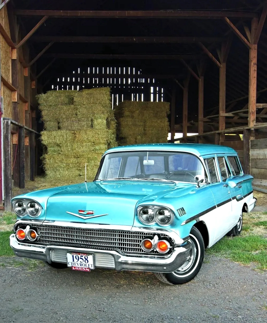 Turquoise and white 1958 Chevrolet Yeoman station wagon in wooden barn