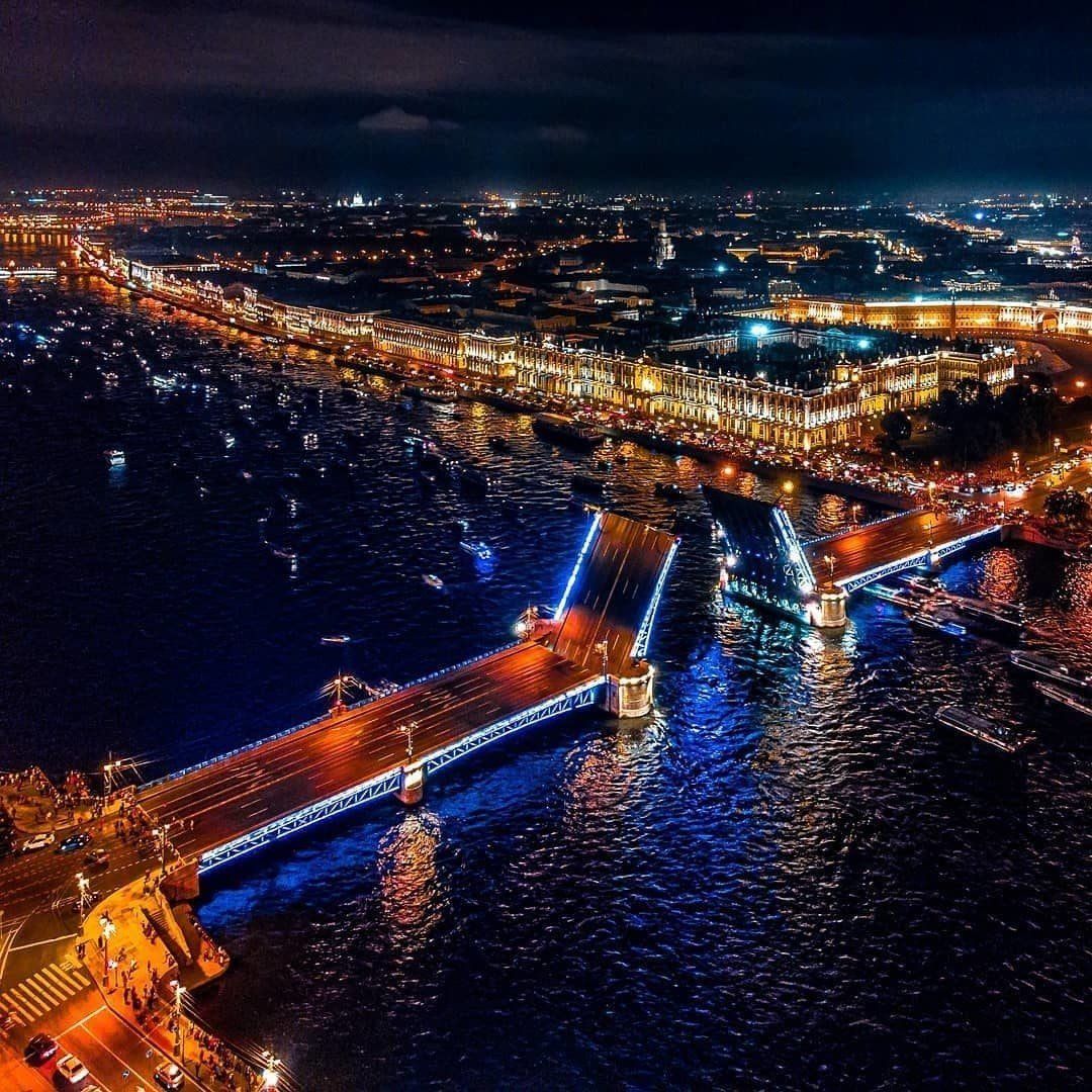 Aerial night view of Saint Petersburg with lit bridges crossing the Neva River and city lights