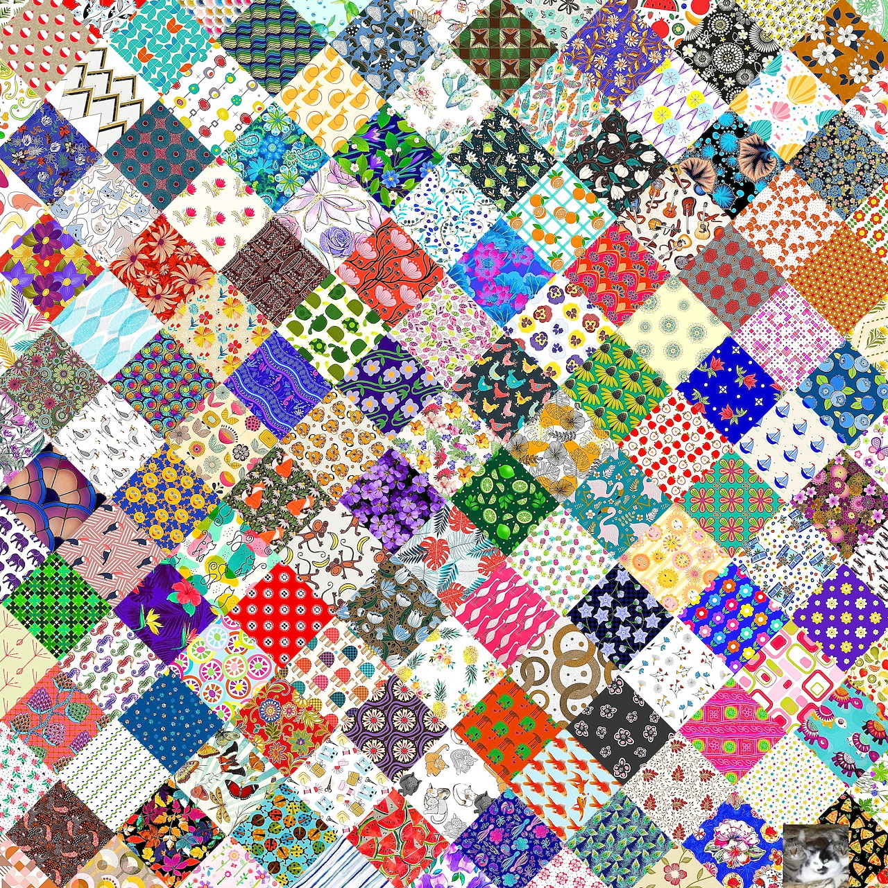 Colorful patchwork quilt with diamond-shaped fabric patches in various patterns and colors arranged diagonally
