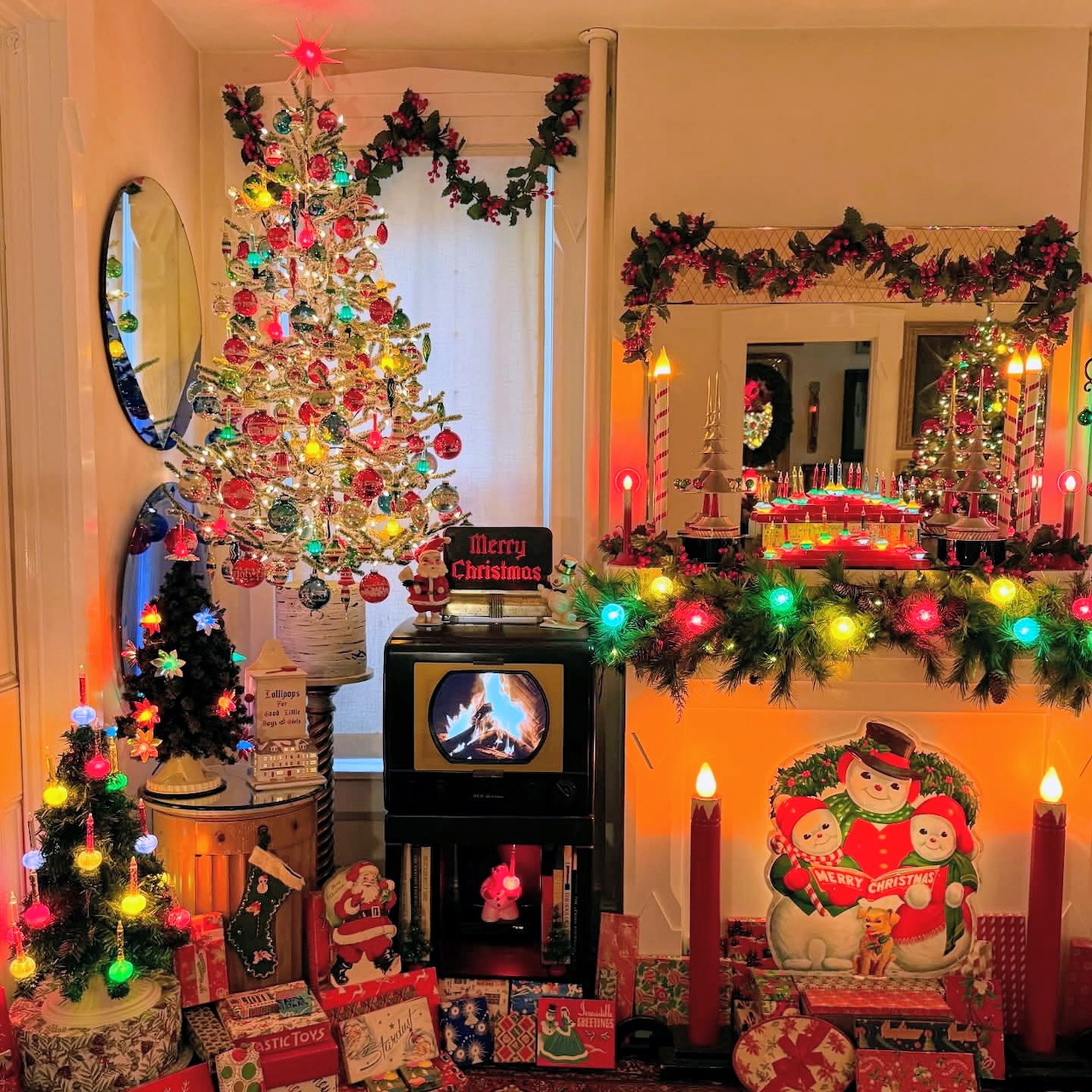 Vintage Christmas living room with lit tree, fireplace, garland, and colorful lights
