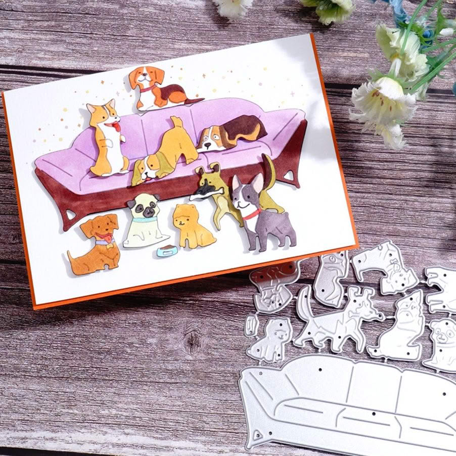 Greeting card with cartoon dogs on a wooden table beside dog-shaped paper pieces and white flowers
