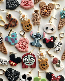 Assorted Disney character keychains including Mickey, Stitch, and Winnie the Pooh displayed on white surface
