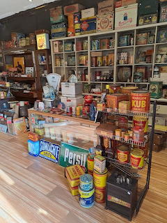 Vintage Dutch grocery store interior with retro tins, cans, and old product packaging on shelves