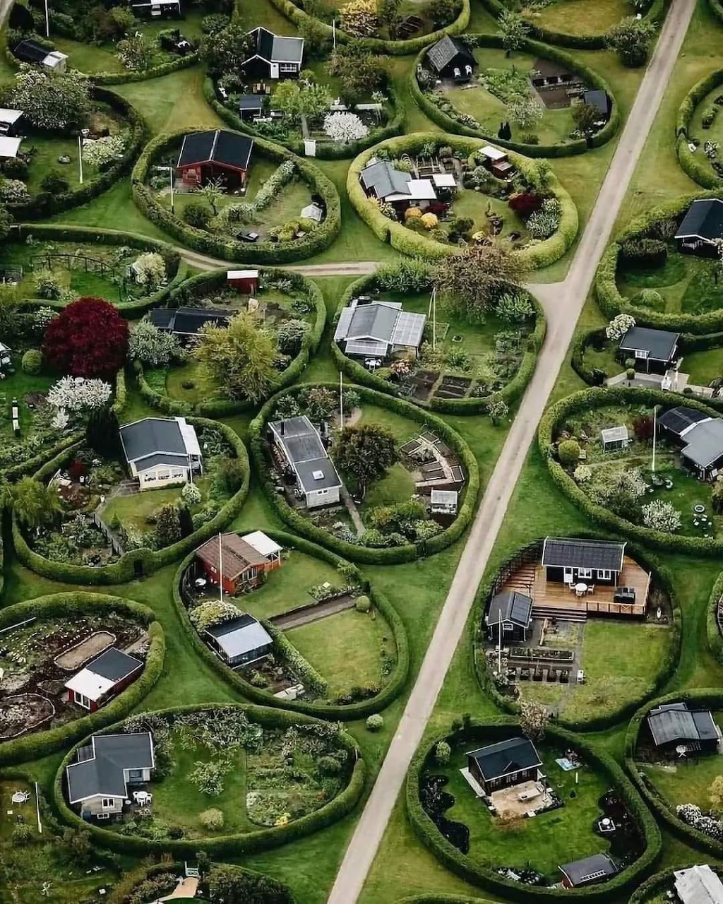 Aerial view of circular residential plots with houses and gardens in Denmark