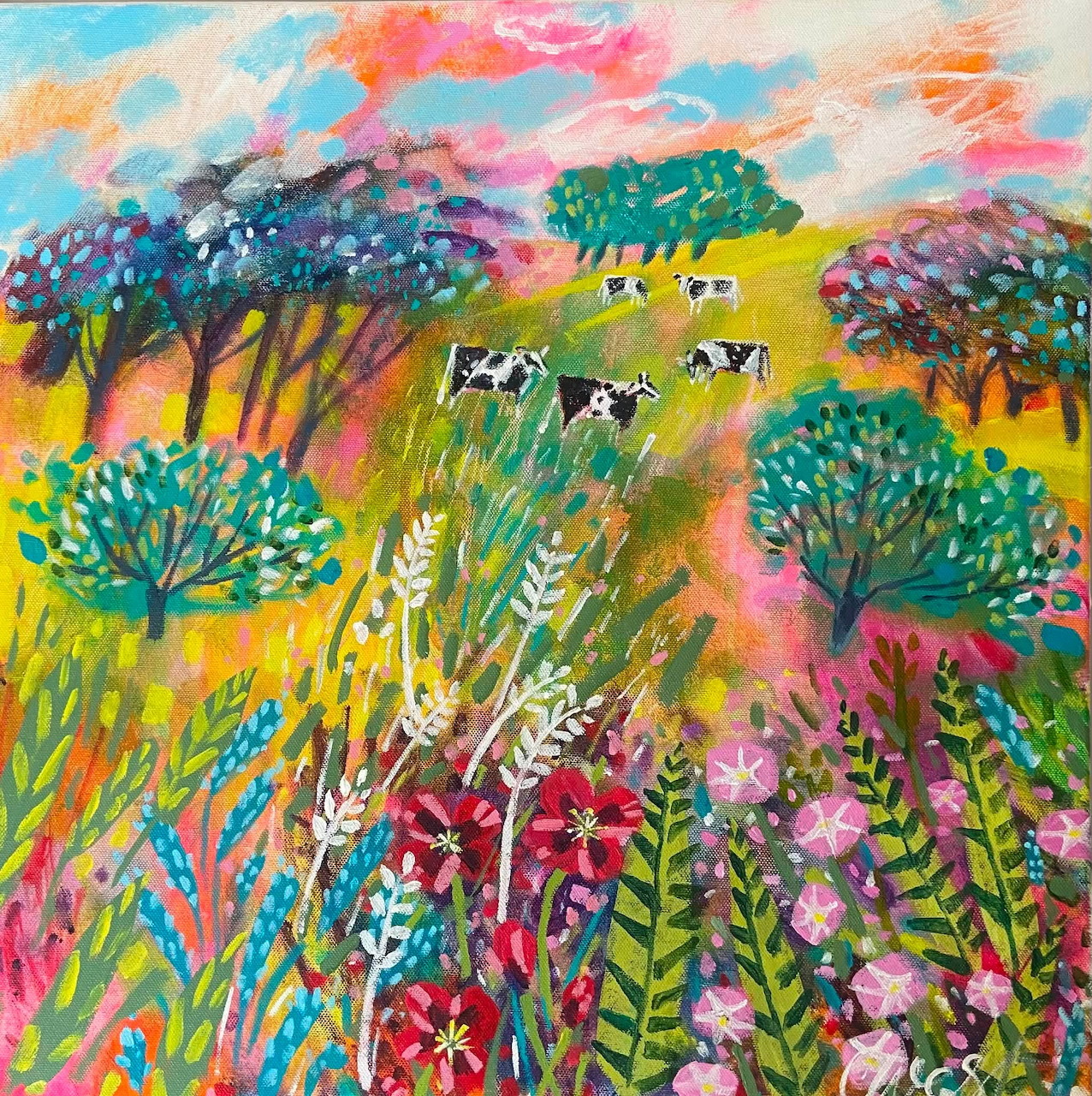 Colorful folk-art painting of cows grazing in a flower-filled pasture beneath patterned trees.