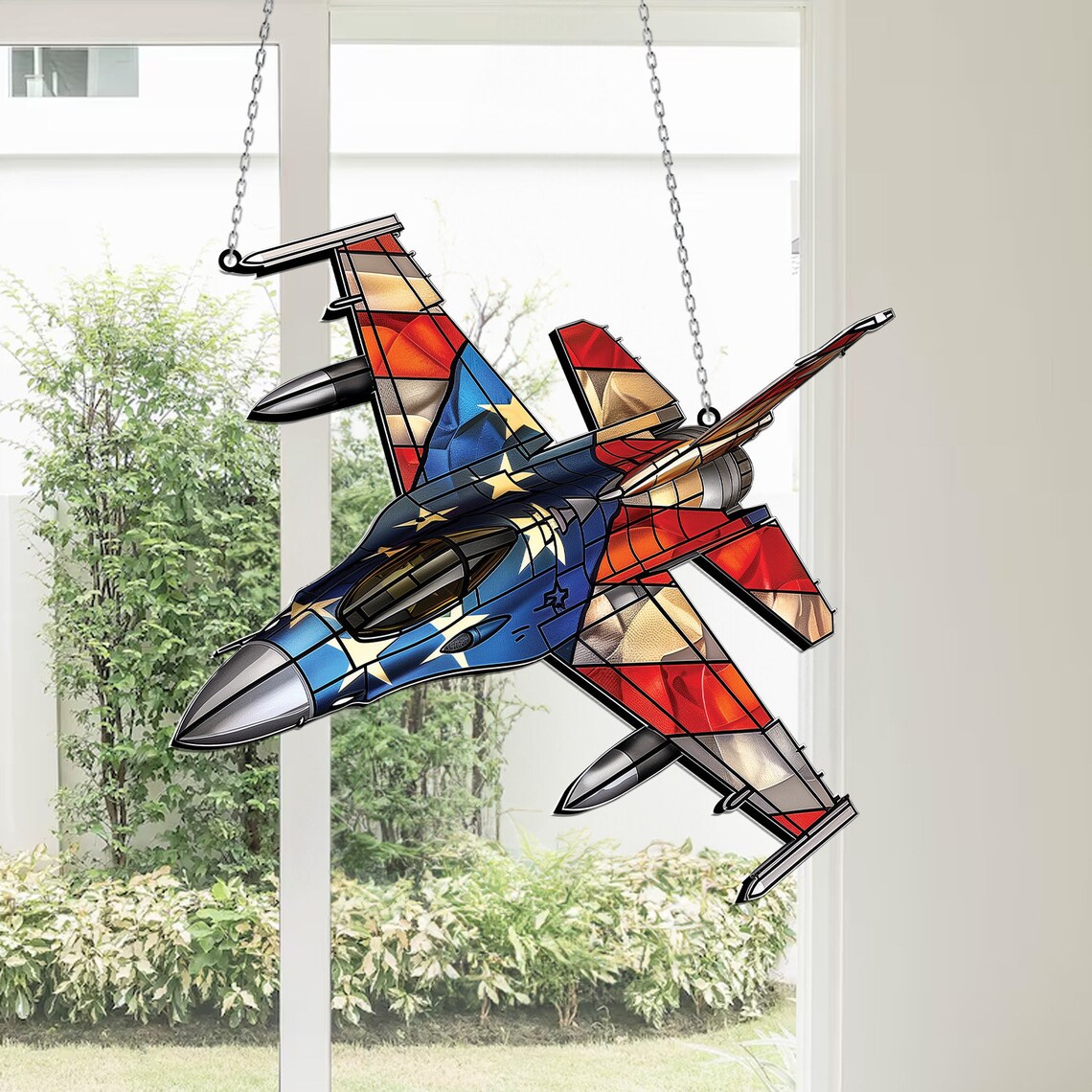 Colorful stained glass airplane suncatcher hanging in a window