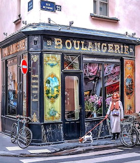 Woman with dog walking past traditional French bakery on Paris street corner