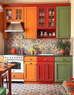 Colorful kitchen with orange, red and green cabinets and mosaic backsplash