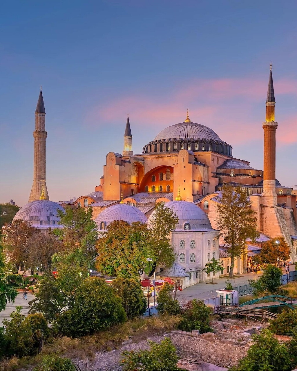 Hagia Sophia mosque with dome and minarets illuminated at dusk in Istanbul, Turkey