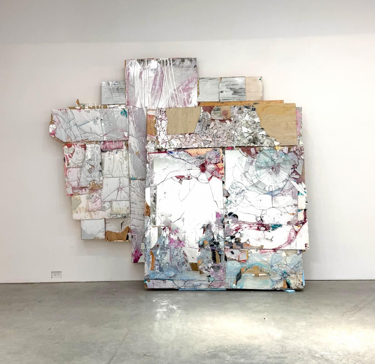 Abstract mixed media wall assemblage in a minimalist gallery interior