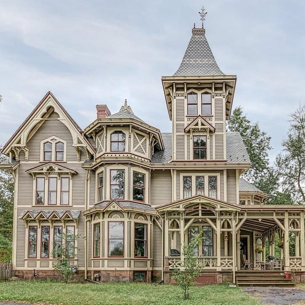 Elaborate Victorian Gothic mansion with tower and ornate architectural details