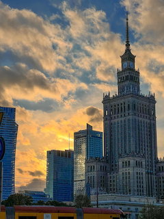 Palace of Culture and Science in Warsaw with nearby skyscrapers at sunset