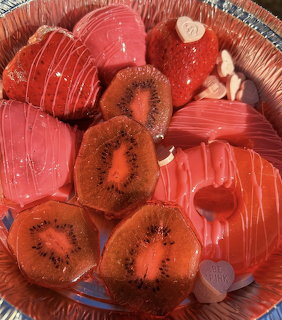 Colorful candied fruit slices including kiwi, pineapple, and strawberry in decorative arrangement