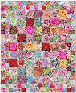 Colorful patchwork quilt with floral fabric squares in pink, red, and purple tones