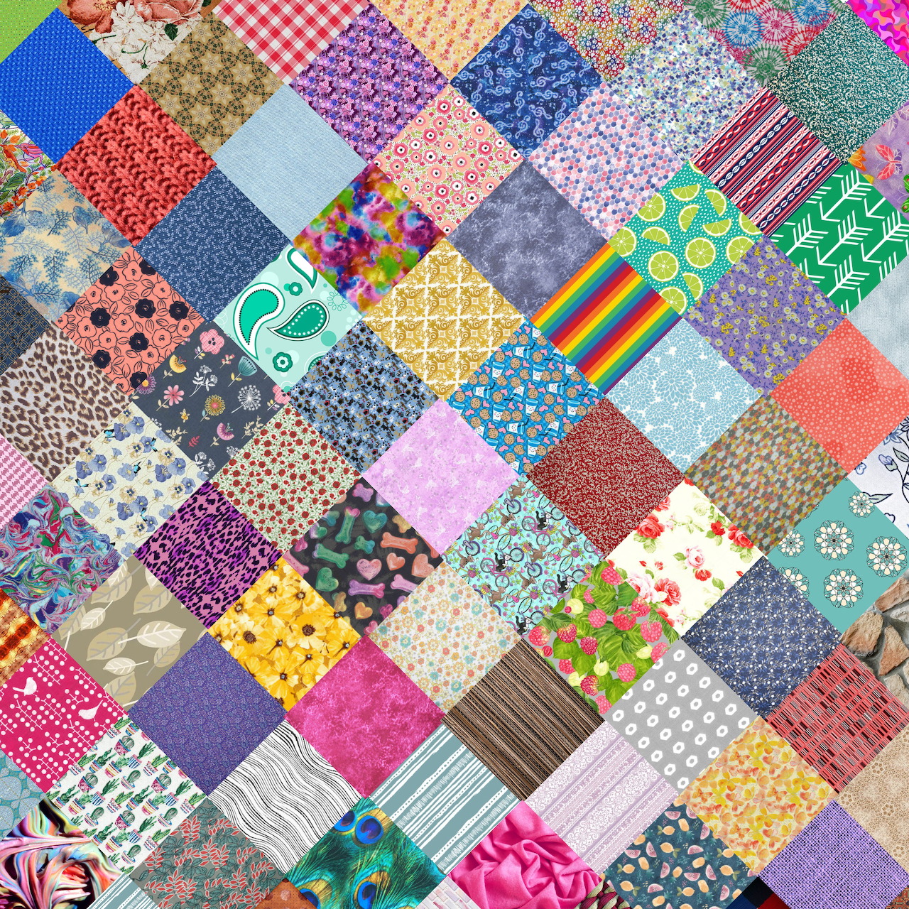 Colorful patchwork quilt with diverse fabric patterns including florals, dots, stripes and geometric designs