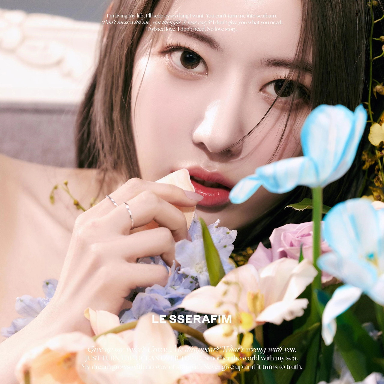 Close-up of a young woman with flowers in soft pastel colors