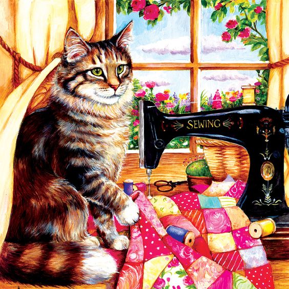 Tabby cat next to vintage sewing machine with colorful quilt pieces and sunny window behind
