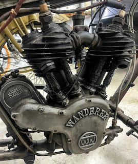 Close-up of a black vintage Wanderer motorcycle engine with cooling fins and branded casing
