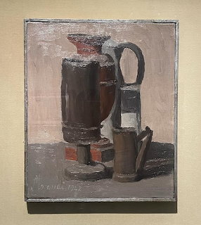 Still life painting of bottles and jugs in muted brown and grey tones by Morandi