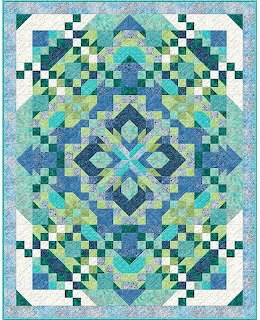 Colorful geometric patchwork quilt with blue, green, and teal diamond and checkerboard patterns