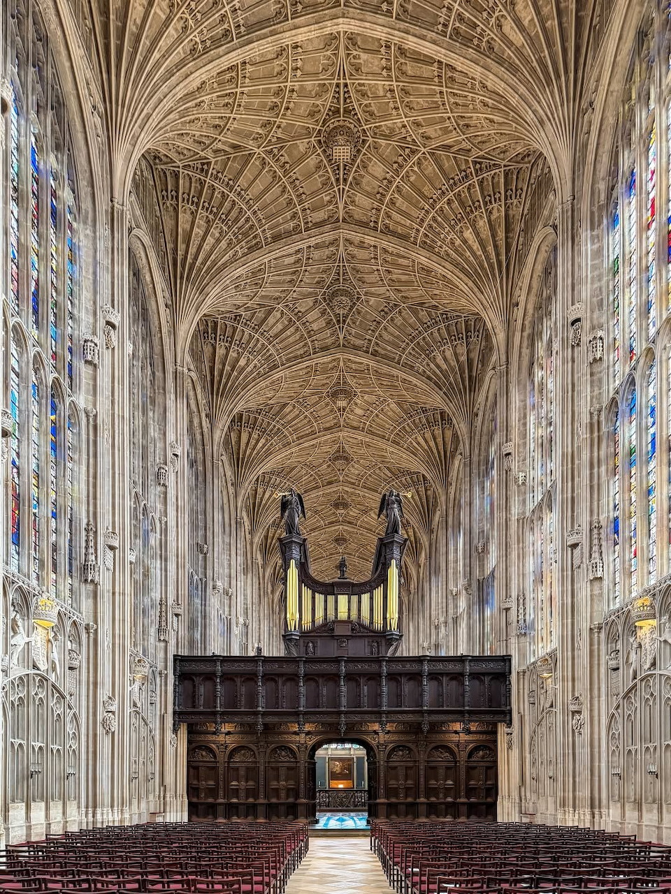 Interior of King's College Chapel with elaborate fan vaulted ceiling and stained glass windows