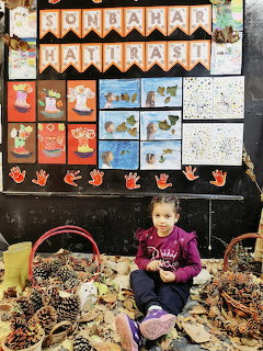Child With Autumn Crafts Display