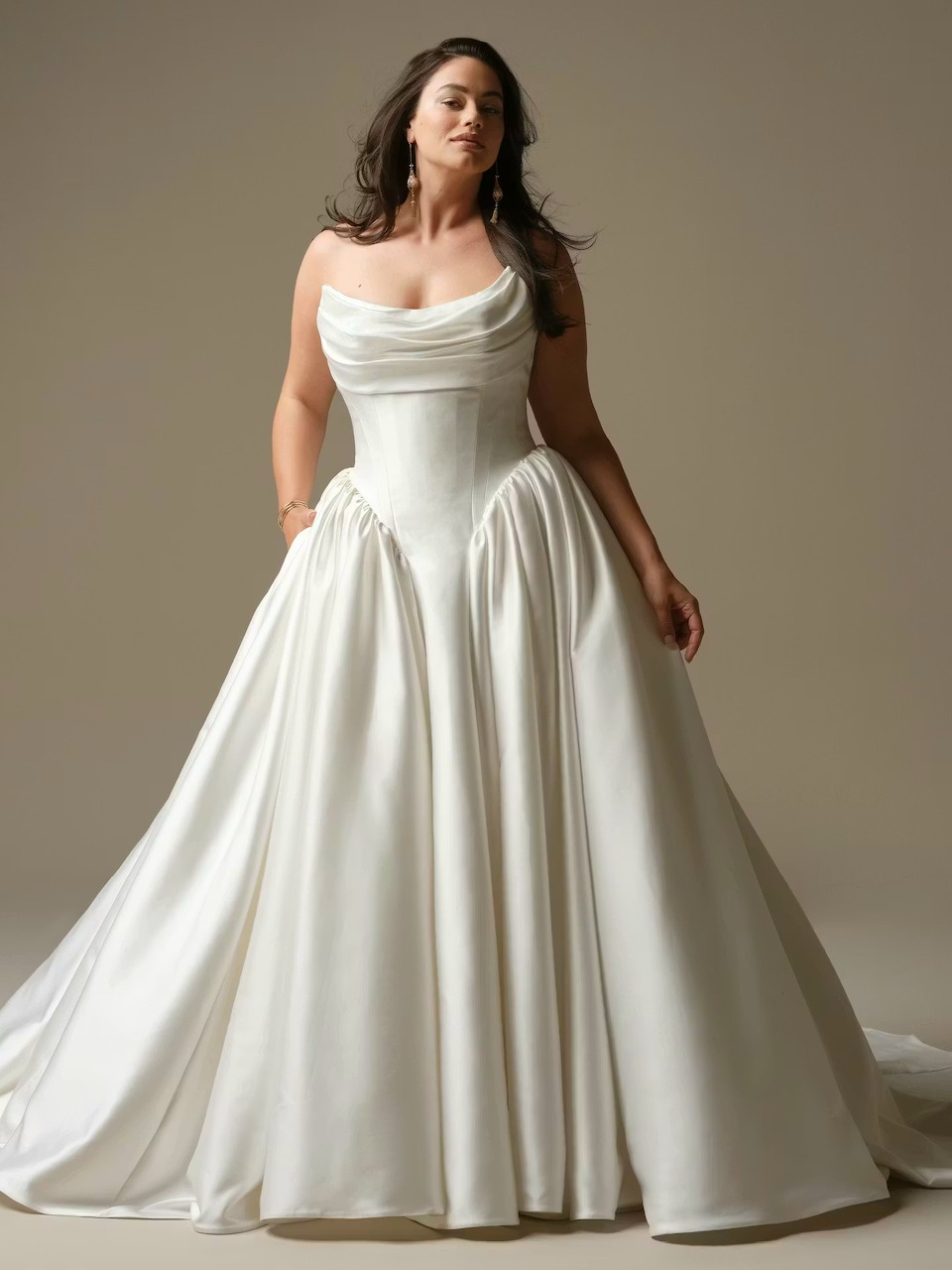 Woman wearing white strapless ballgown wedding dress with full satin skirt