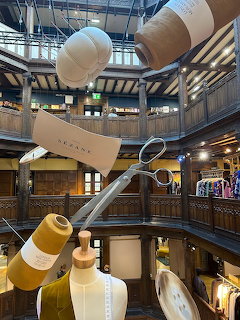 Interior view of Liberty's London department store showing Tudor-style wooden architecture and hanging decorations